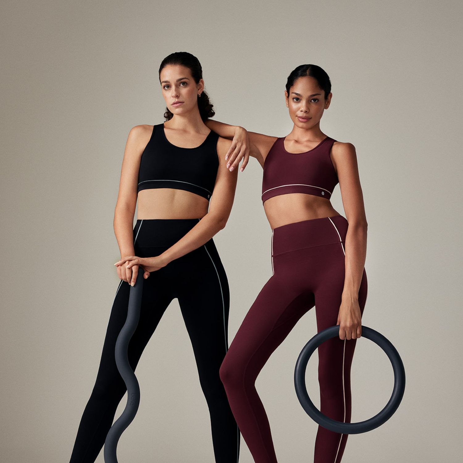 Two women posing in athletic wear