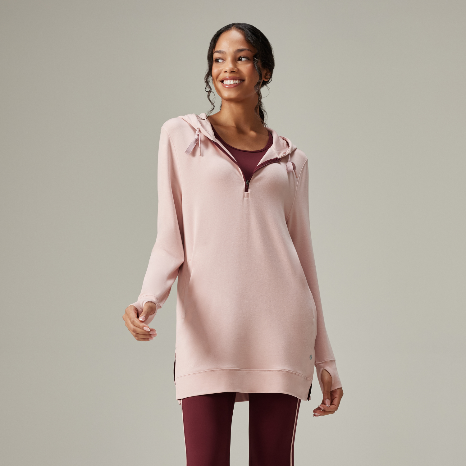 Woman wearing pink thigh-long hoodie