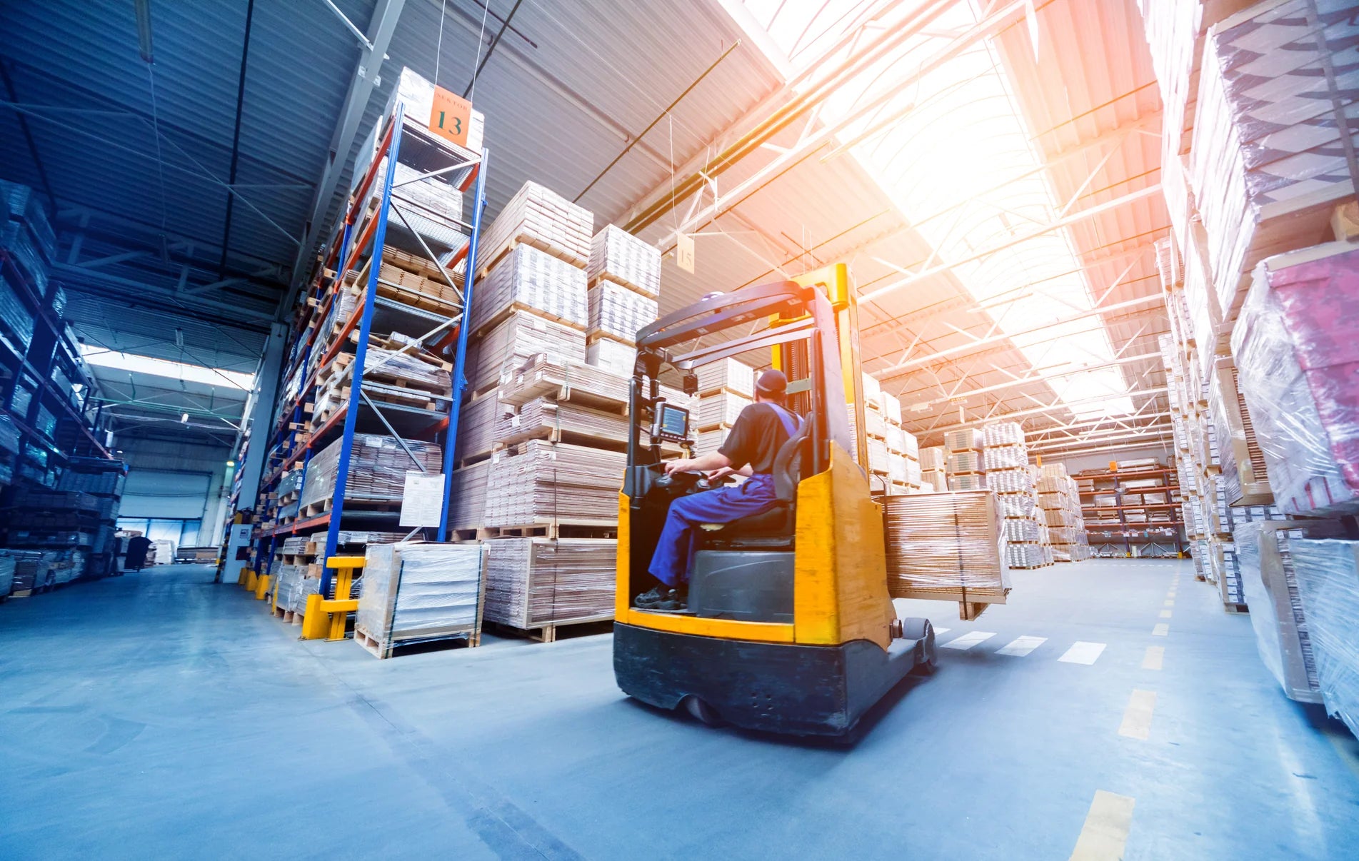 Man driving a forklift in warehouse