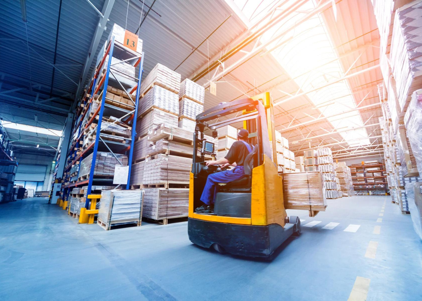 Man driving forklift in warehouse