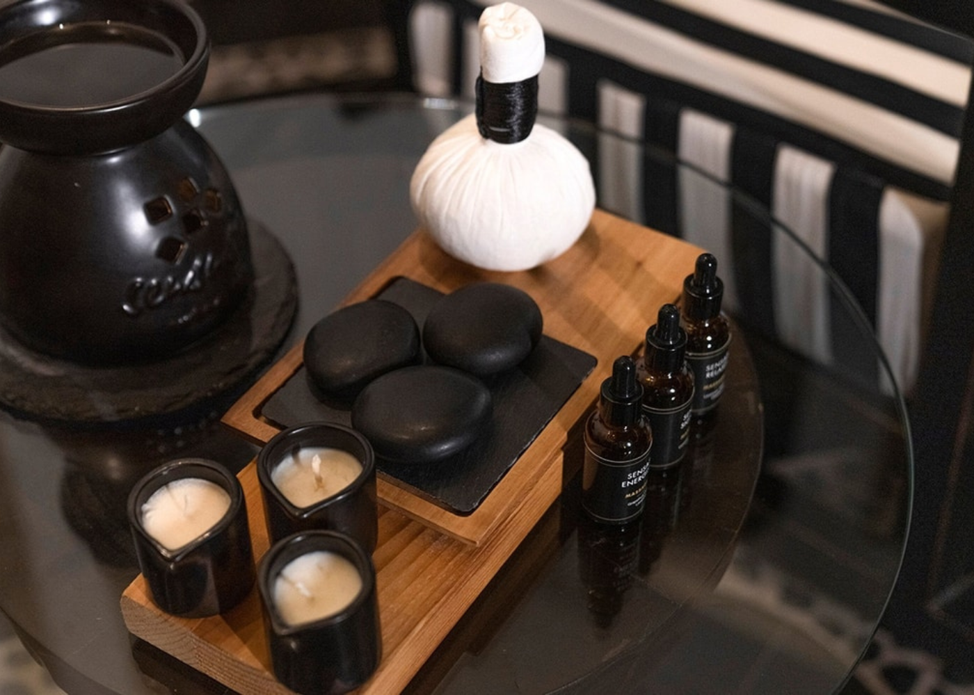 Coffee table with candles, hot stones, herbal compress, and scented oils