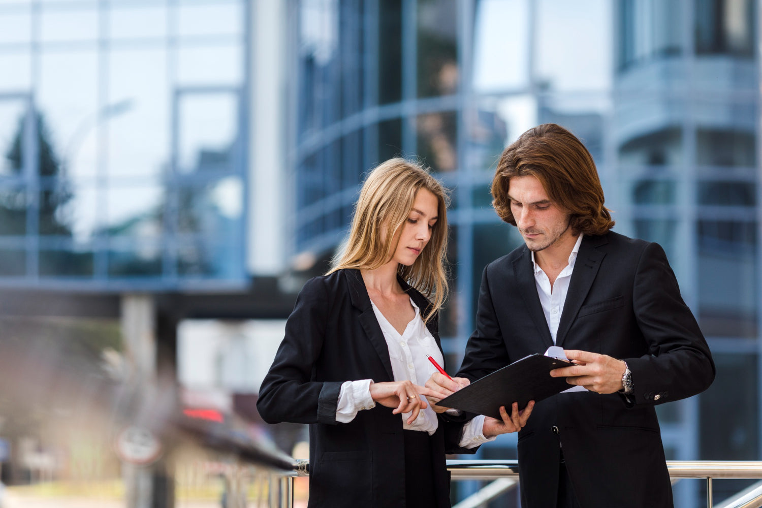 Man and woman checking clipboard