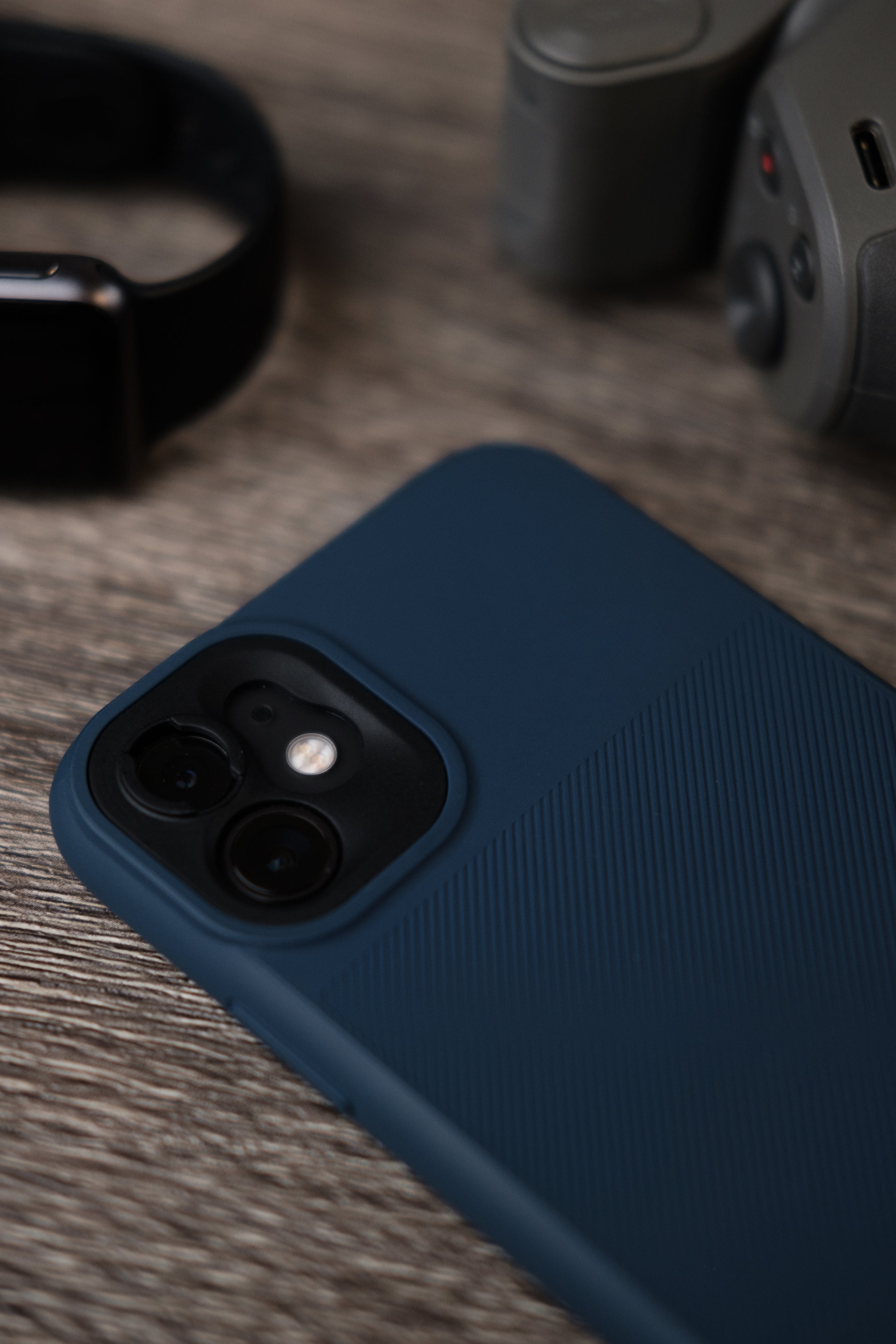 Back of mobile phone and accessories on wood surface