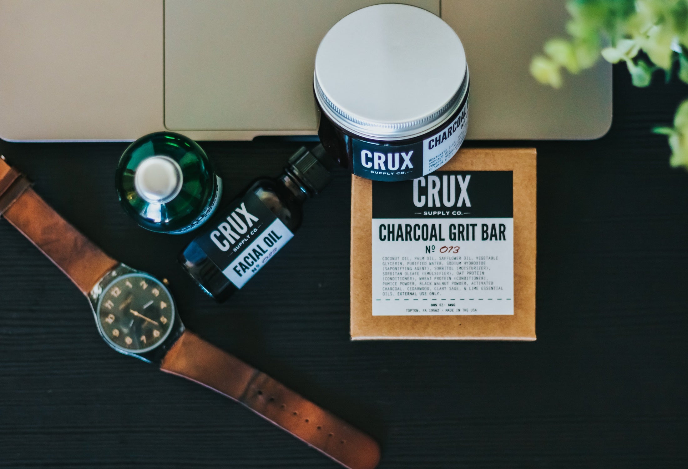 A product placement flat lay with soaps and male grooming products and a watch.