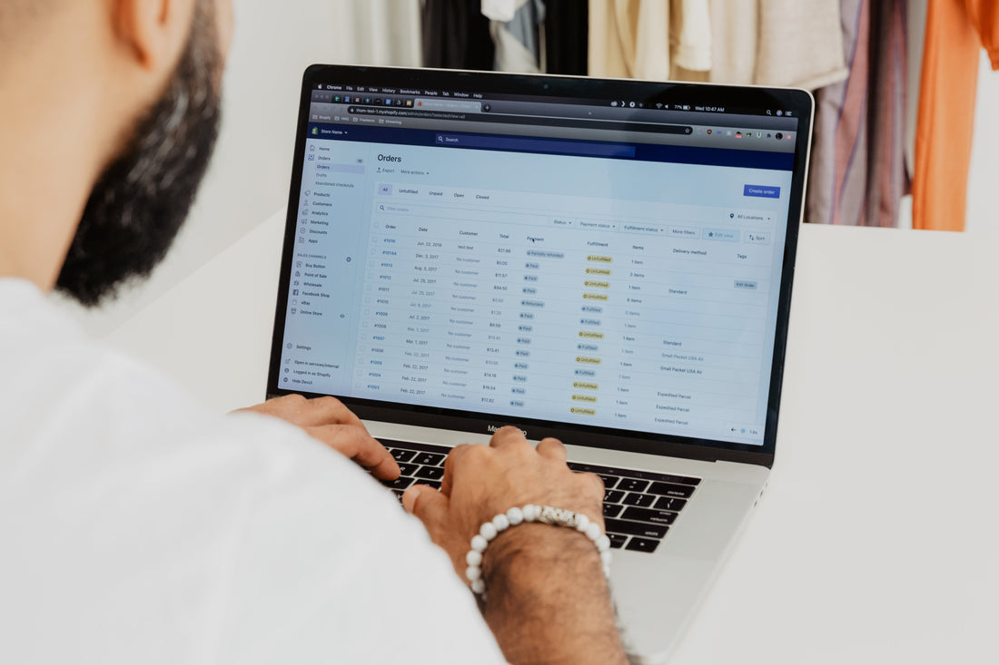 Man on laptop computer viewing Shopify admin product page