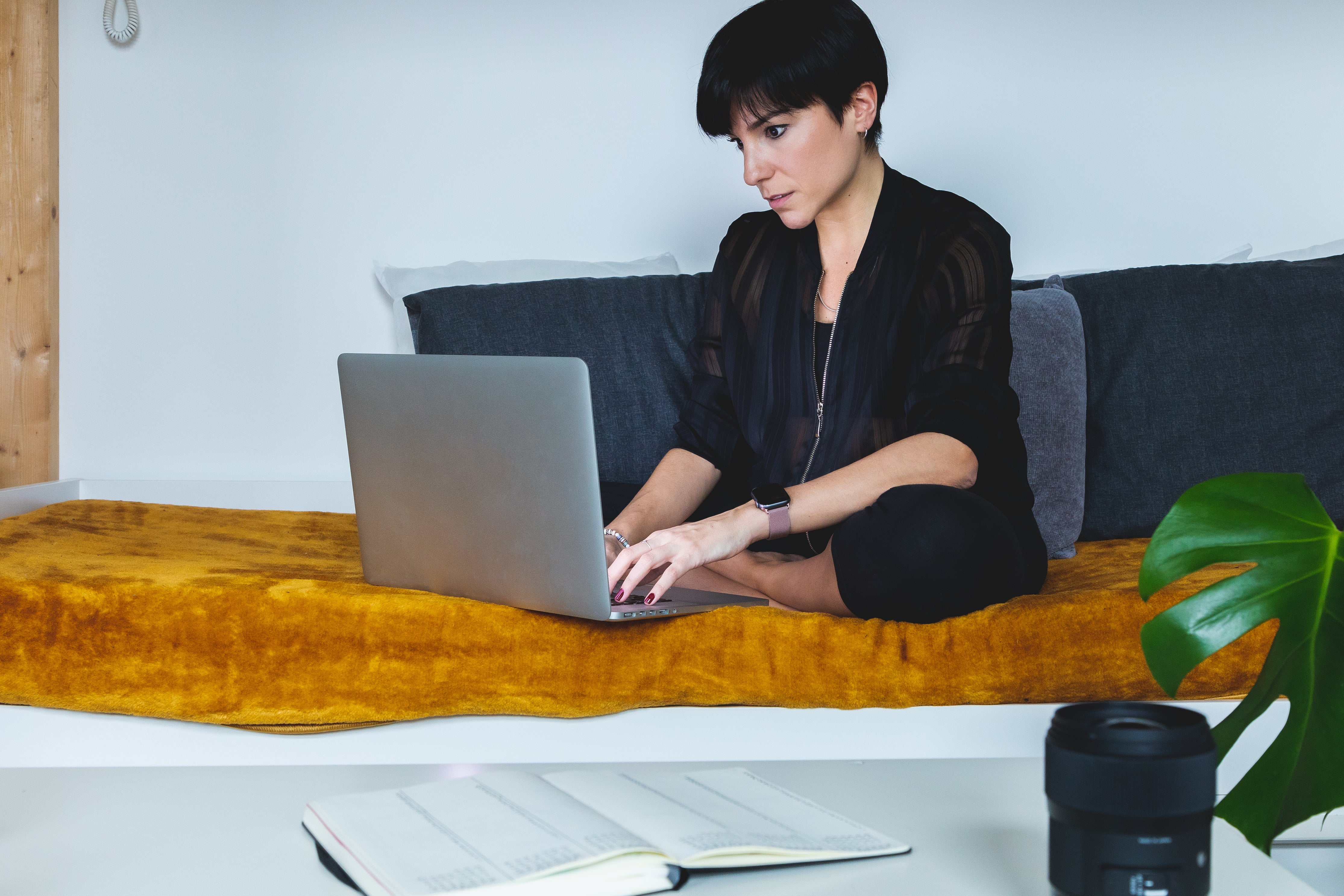 Person Sits Crossed Legged Working On Their Laptop Photo